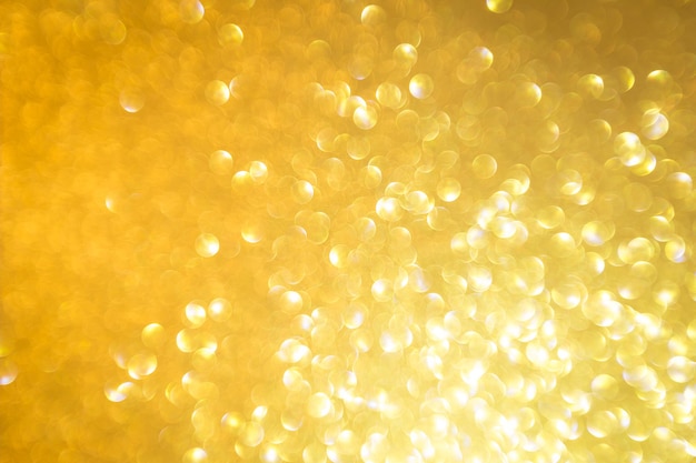 Abstracte gouden glitter feestelijke kerst textuur achtergrond vervagen met bokeh licht