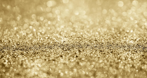 Abstracte gouden glitter schittering met bokeh achtergrond