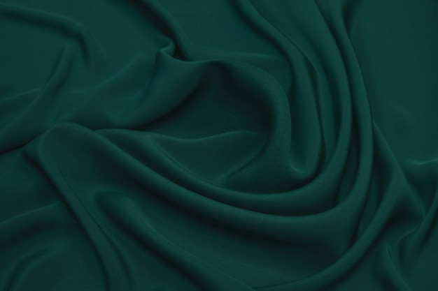 Abstracte groene kleur zijde chiffon stof textuur achtergrond.