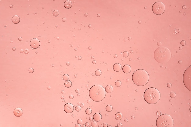 Abstracte roze olie bubbels achtergrond Cosmetisch vloeibaar schoonheidsproduct