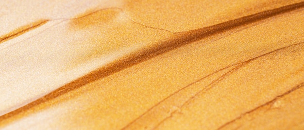 Abstracte sprankelende textuur. Brons oranje achtergrond met glinsterende uitstrijkjes. Feestelijke achtergrond