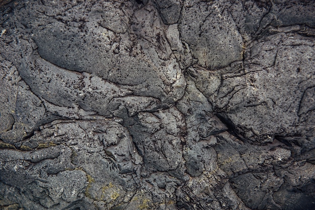 Foto abstracte stenen achtergrond. ruw oppervlak van grijze rots met scheuren en natuurlijk patroon