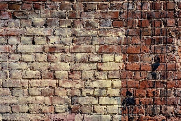 Abstracte textuur van een oude bakstenen muur voor een achtergrond of voor behang van gele en bruine kleur
