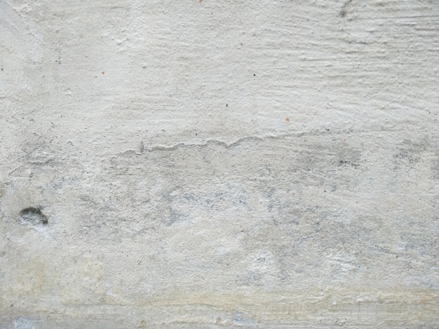 Abstracte textuurachtergrond van poreuze, gebarsten en doorstane cementmuur