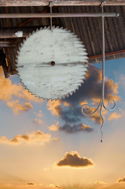 Abstraction circular saw against the sky at sunset