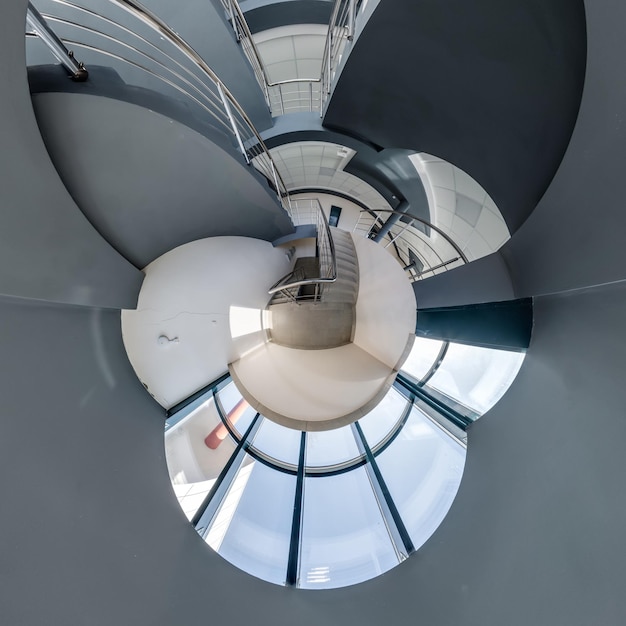 Abstractly twisted into spherical 360 panorama interior of modern office with hall staircase and panoramic windows