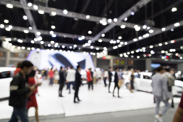 Photo abtract blur people in exhibition hall motor show event background