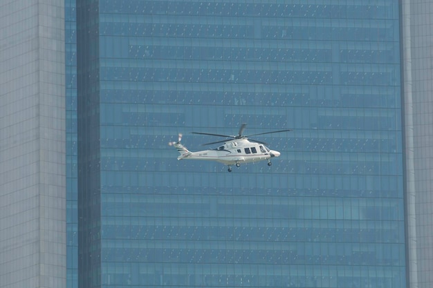 Abu Dhabi UAE march 18 2024 Helicopter flying over skyscrapers in the city of Abu Dhabi