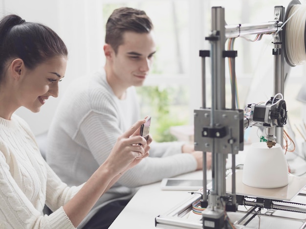 Academic students using a 3D printer in the lab