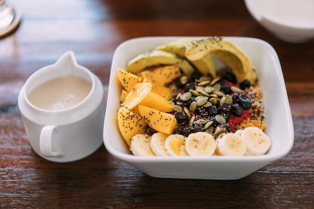 Acai bowl mix with fresh mango, avocado, banana, berries, sunflower seeds, chia seeds and cereal.