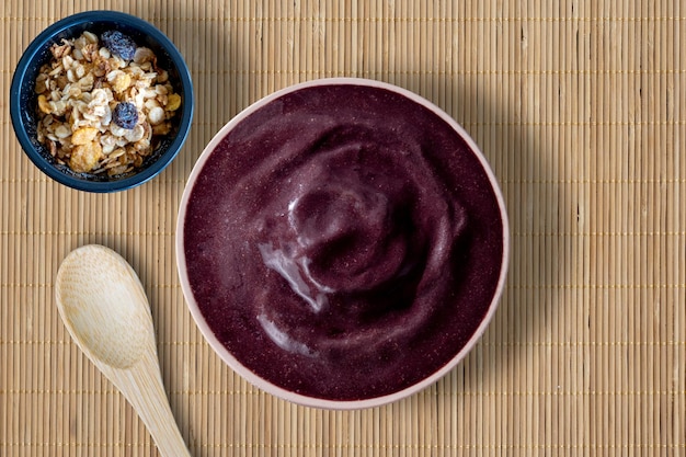 Acai bowl with granola on the side Wooden background Acai Brazil Top view