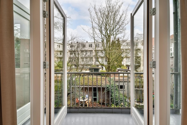 Access to a cozy balcony of a modern house with wooden doors and a metal fence