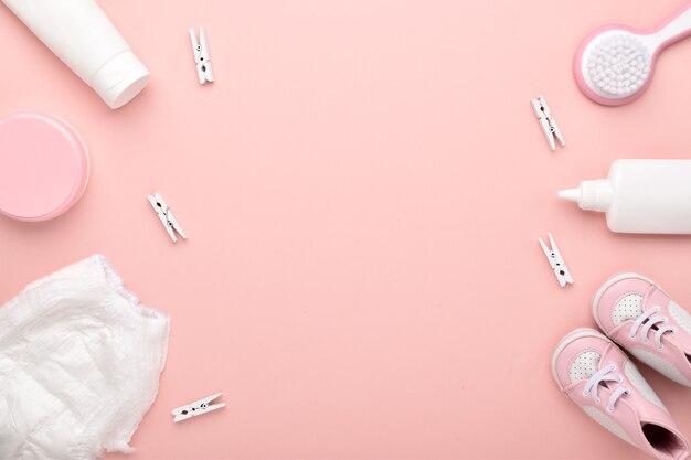 Accessories for the baby on a pink background. Child care. Flat lay, top view, copy space.