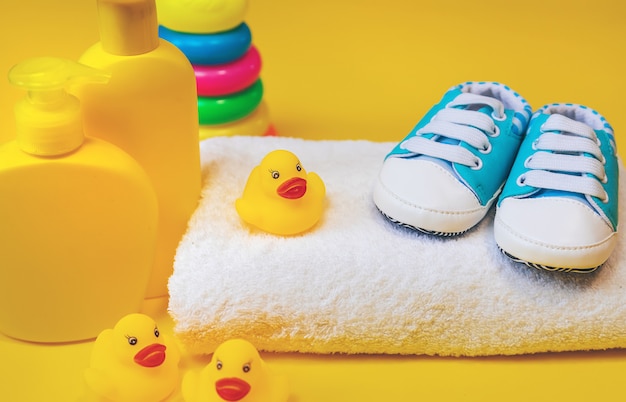 Accessories for bathing newborns on a yellow. 