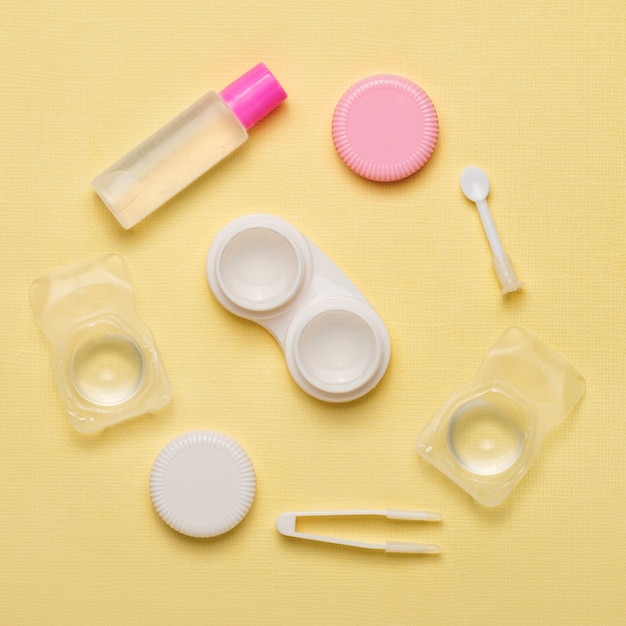 Accessories for contact lenses on a yellow background