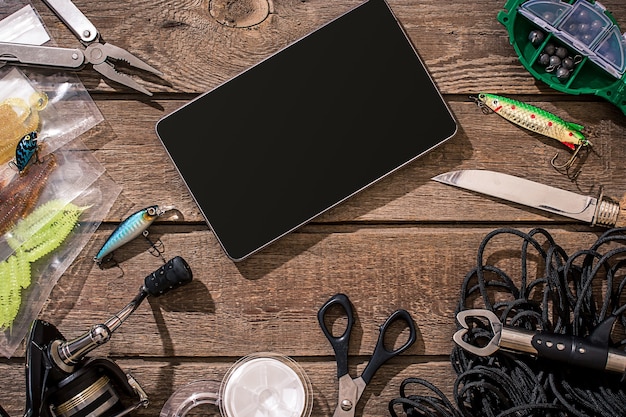 Accessories for fishing on the background of wood top view