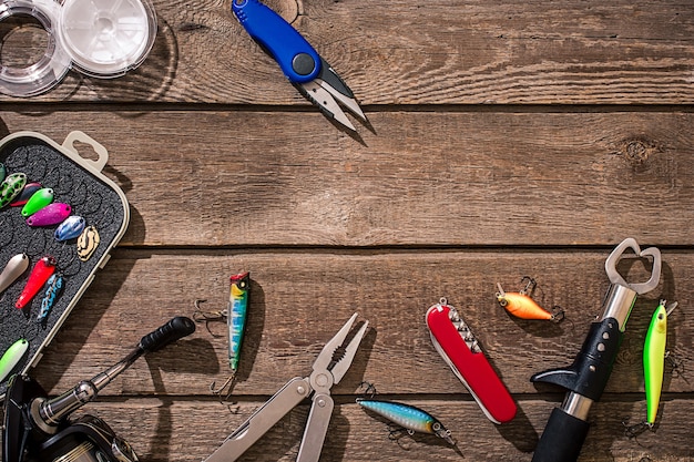 Accessories for fishing on the background of wood top view