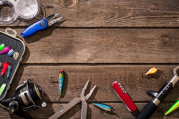 Accessories for fishing on the background of wood top view