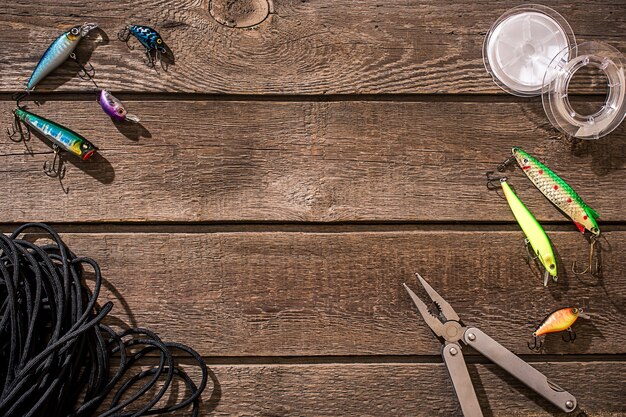 Photo accessories for fishing on the background of wood top view