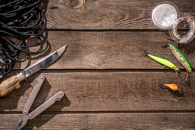 Accessories for fishing on the background of wood top view