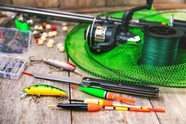 Photo accessories for fishing on a wooden background. selective focus. fishing.