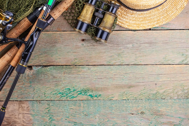 Accessories for fishing on a wooden background
