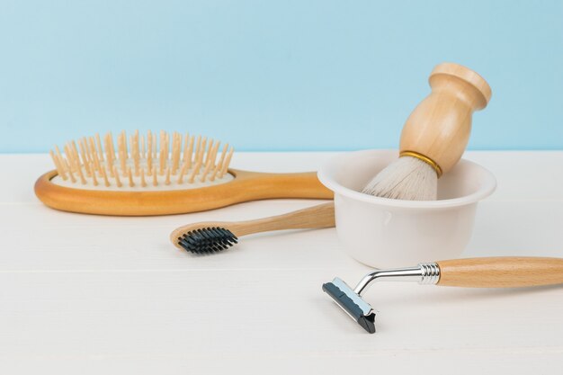 Accessories for men's hygiene on a white table on a blue background.