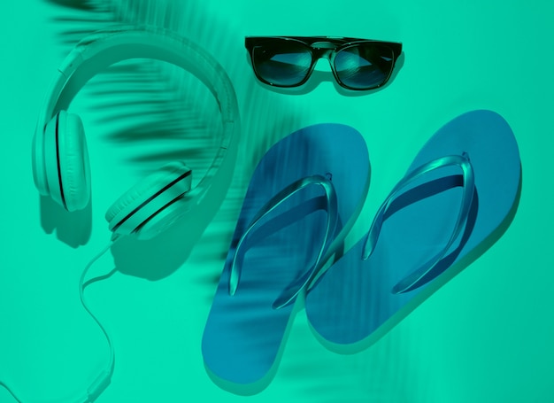 Accessories for relaxing on the beach flip flops headphones sunglasses