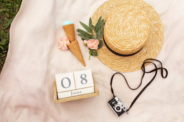 Accessories of a romantic girl traveler. Wicker hat and retro camera