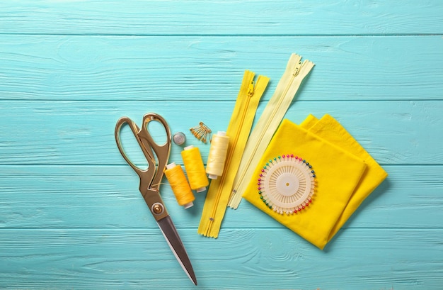 Accessories for sewing on wooden background