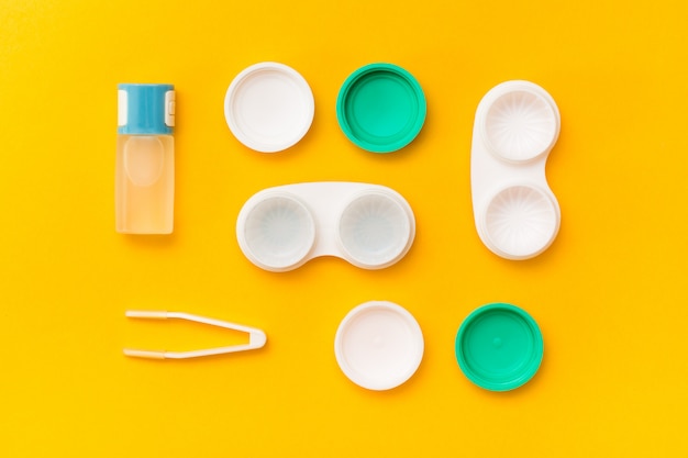 Photo accessories for storing lenses: a bottle of liquid, open containers and tweezers