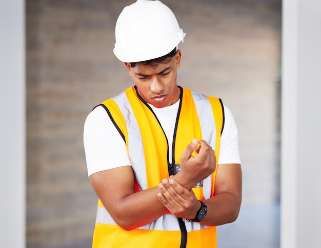 Accident building and wrist pain with construction worker man on site for maintenance or repair Architecture design or project management and engineer with emergency fail or mistake for injury
