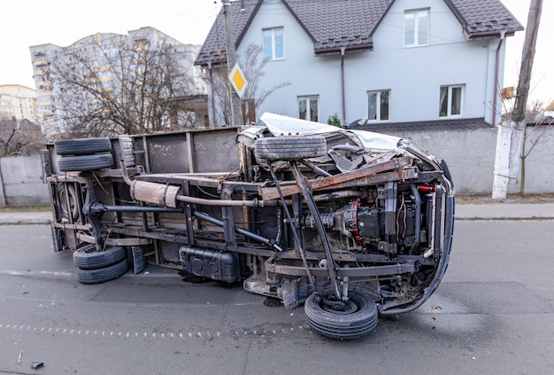 Accident due to speeding. An overturned truck lies in the middle of the street.