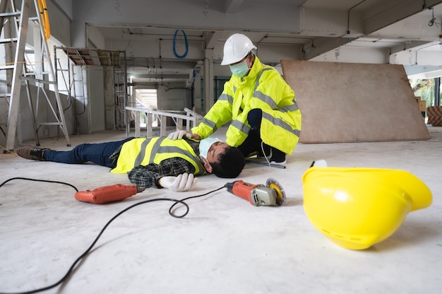 an accident of a man worker at the construction site. the assist those injured in the primary. selection focus on an injured person.