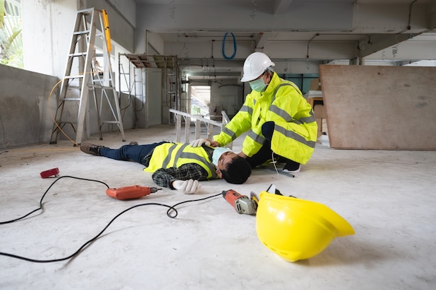 an accident of a man worker at the construction site. the assist those injured in the primary. selection focus on an injured person.
