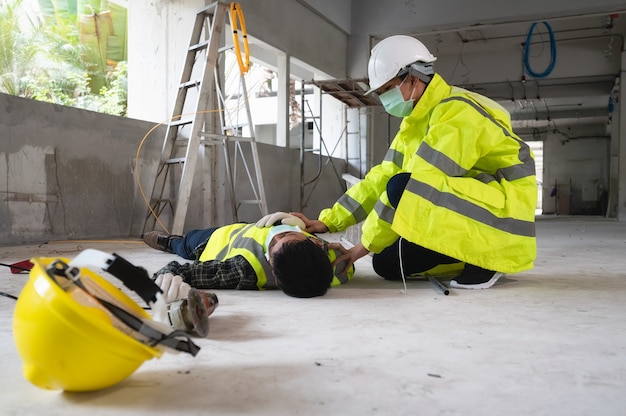 an accident of a man worker at the construction site. the assist those injured in the primary. selection focus on an injured person.