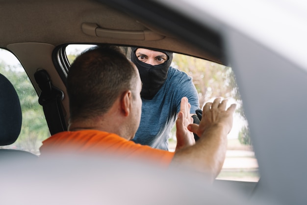 Accident between two cars with two people outdoors