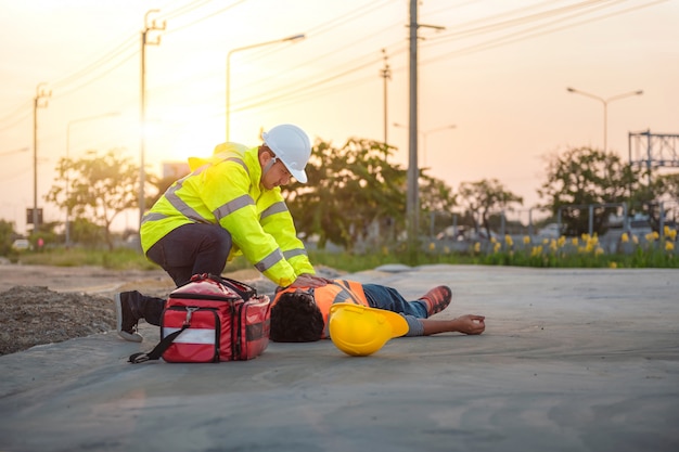 Photo accident at work of construction labor people, basic first aid and cpr training at outdoor.