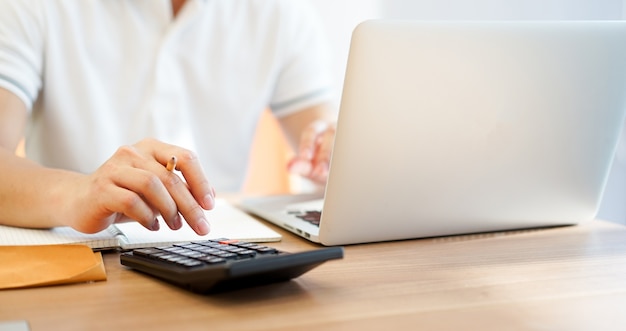 Accountant business man pressing on calculator