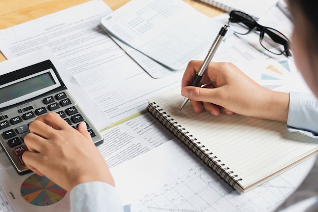 accountant using calculator for calculate budget finance on table in office 