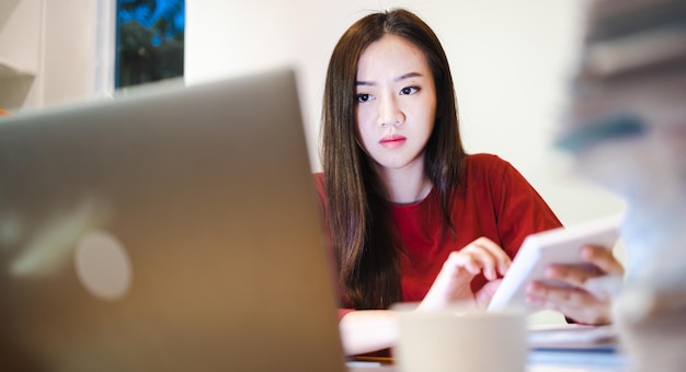 Accountant woman using a calculator during overtime at home at\
night workaholic people concept