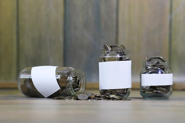 Accumulated coins stacked in glass jars on the floor