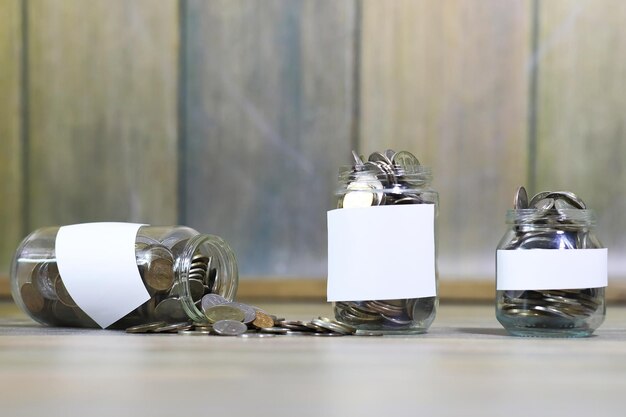 Accumulated coins stacked in glass jars on the floor