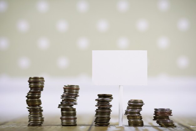 Accumulated coins stacked in piles on the wooden floor