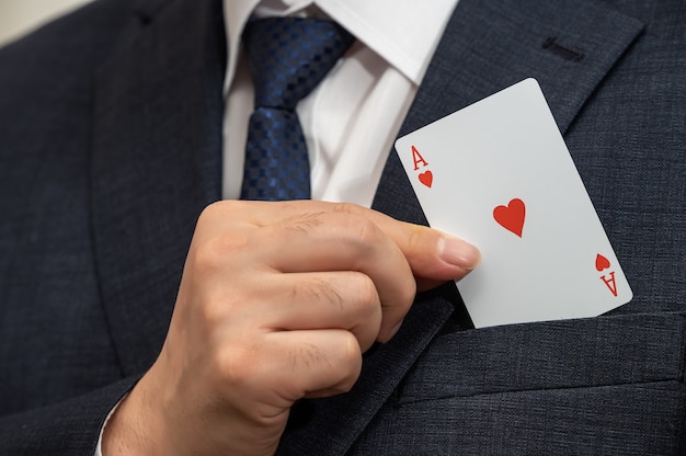 Photo ace card in the hand of a businessman in a suit