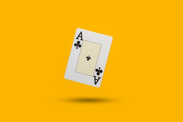 An ace of clver card floating on a yellow background with copy space