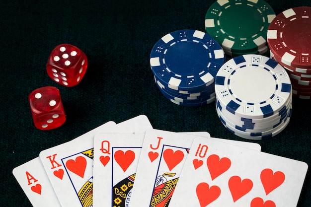 Ace playing cards with red dice. Casino betting and gambling concept and poker chips.