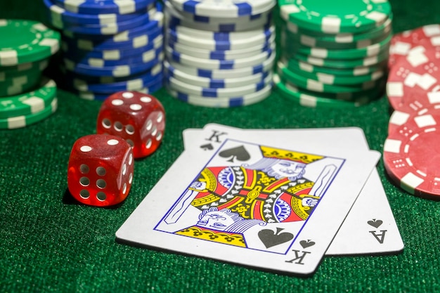 Ace playing cards with red dice. Casino betting and gambling concept and poker chips.