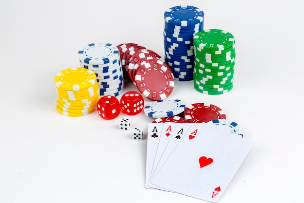 Ace playing cards with red dice. Casino betting and gambling concept and poker chips.