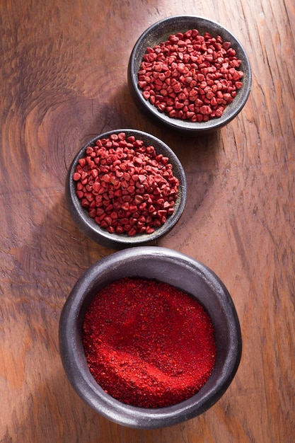 Achiote in bowl on wooden background achiote paste